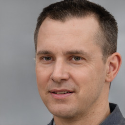 Joyful white adult male with short  brown hair and brown eyes