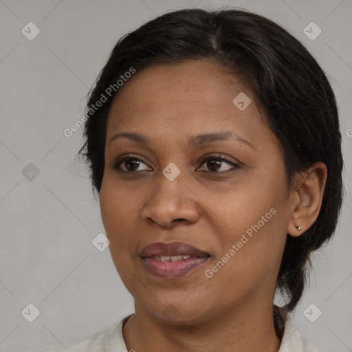 Joyful black adult female with medium  brown hair and brown eyes