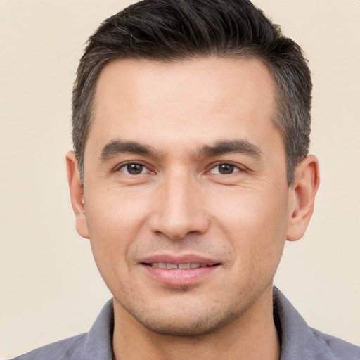 Joyful white young-adult male with short  brown hair and brown eyes