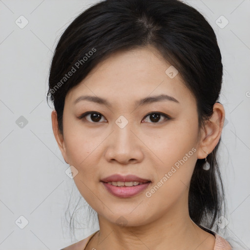 Joyful asian young-adult female with medium  black hair and brown eyes