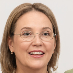 Joyful white adult female with medium  brown hair and grey eyes