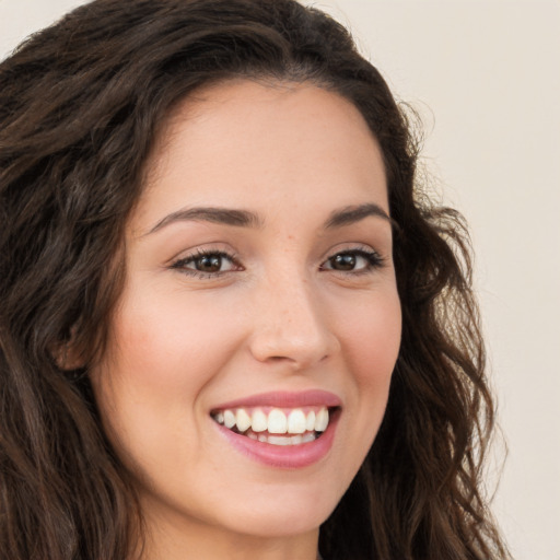 Joyful white young-adult female with long  brown hair and brown eyes