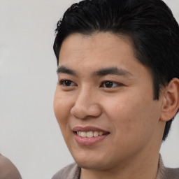 Joyful latino young-adult male with short  brown hair and brown eyes