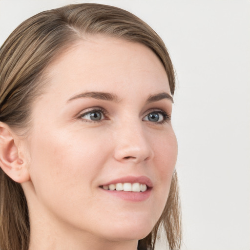 Joyful white young-adult female with long  brown hair and blue eyes