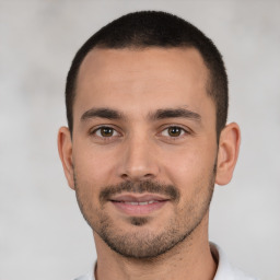 Joyful white young-adult male with short  black hair and brown eyes