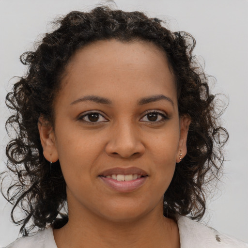 Joyful black young-adult female with medium  brown hair and brown eyes