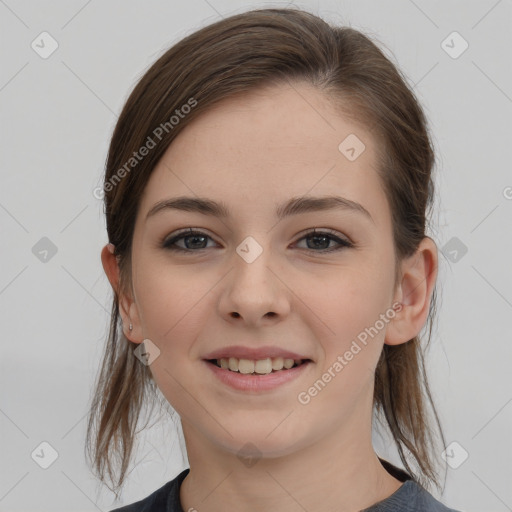 Joyful white young-adult female with medium  brown hair and grey eyes