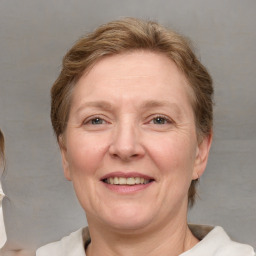 Joyful white adult female with medium  brown hair and blue eyes