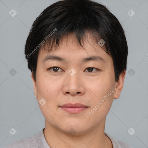 Joyful asian young-adult male with short  brown hair and brown eyes