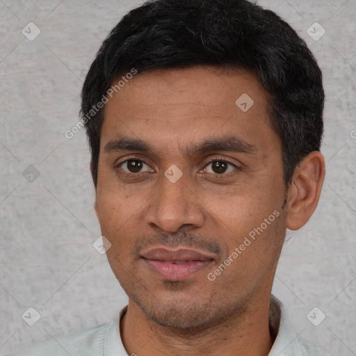 Joyful latino young-adult male with short  black hair and brown eyes