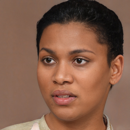 Joyful black young-adult female with short  black hair and brown eyes