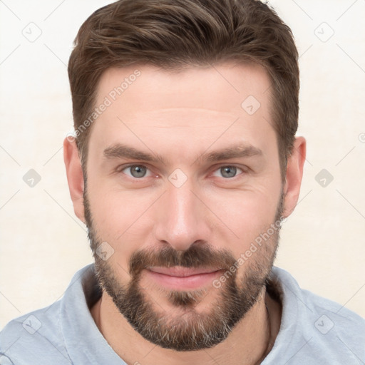 Joyful white young-adult male with short  brown hair and grey eyes