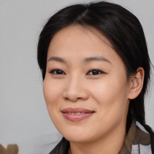 Joyful asian young-adult female with medium  brown hair and brown eyes