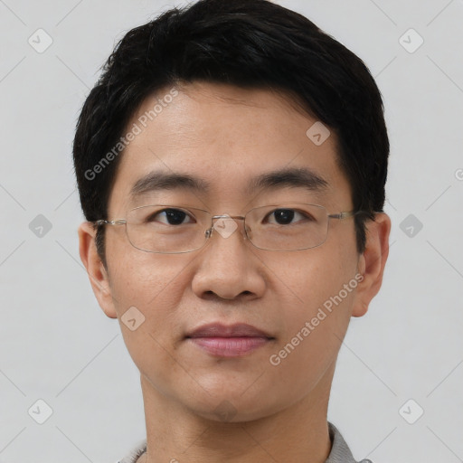 Joyful asian young-adult male with short  black hair and brown eyes