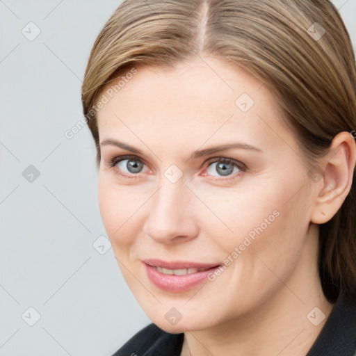 Joyful white young-adult female with medium  brown hair and grey eyes