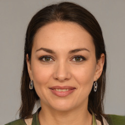 Joyful white young-adult female with medium  brown hair and brown eyes