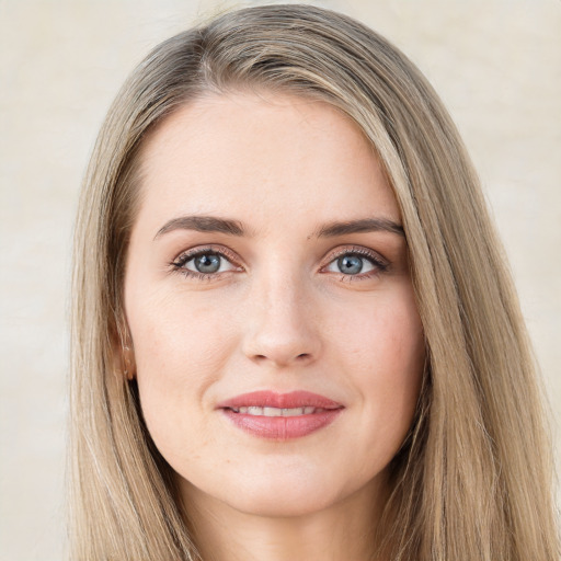 Joyful white young-adult female with long  brown hair and green eyes