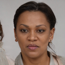 Joyful black adult female with medium  brown hair and brown eyes