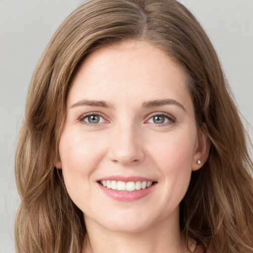 Joyful white young-adult female with long  brown hair and green eyes