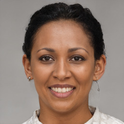 Joyful latino young-adult female with short  brown hair and brown eyes