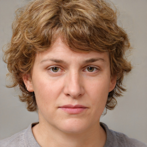 Joyful white young-adult female with medium  brown hair and blue eyes