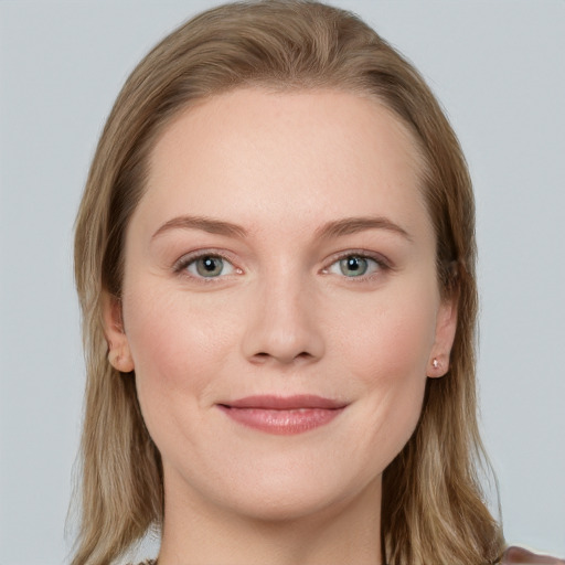 Joyful white young-adult female with long  brown hair and blue eyes