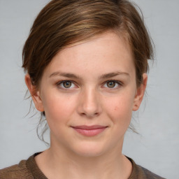 Joyful white young-adult female with medium  brown hair and blue eyes