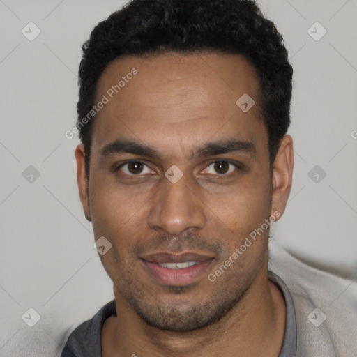 Joyful black young-adult male with short  black hair and brown eyes