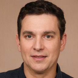 Joyful white adult male with short  brown hair and brown eyes