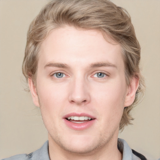 Joyful white young-adult male with short  brown hair and blue eyes