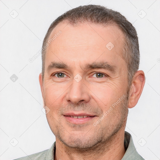 Joyful white adult male with short  brown hair and brown eyes