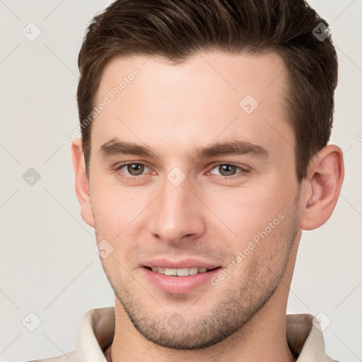 Joyful white young-adult male with short  brown hair and brown eyes