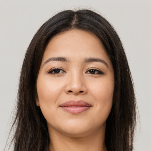 Joyful latino young-adult female with long  brown hair and brown eyes