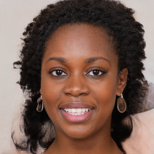 Joyful black young-adult female with medium  black hair and brown eyes