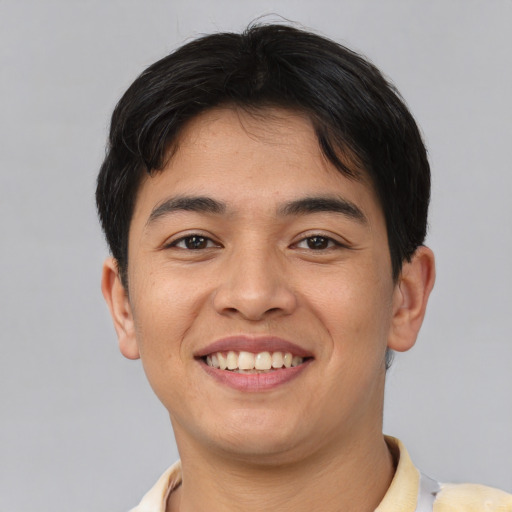 Joyful asian young-adult male with short  black hair and brown eyes