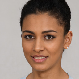 Joyful latino young-adult female with short  brown hair and brown eyes