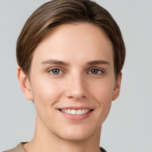 Joyful white young-adult female with short  brown hair and grey eyes