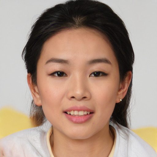 Joyful asian young-adult female with medium  brown hair and brown eyes