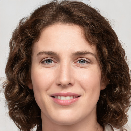 Joyful white young-adult female with medium  brown hair and green eyes