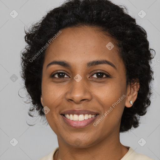 Joyful black young-adult female with long  brown hair and brown eyes