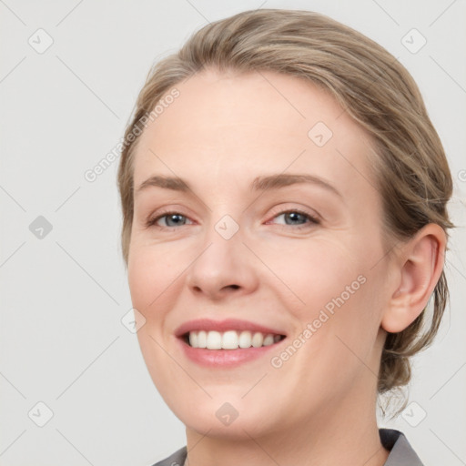 Joyful white young-adult female with medium  brown hair and blue eyes