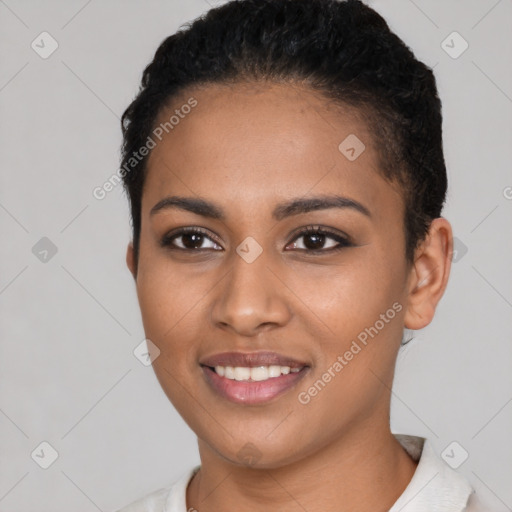 Joyful black young-adult female with short  black hair and brown eyes