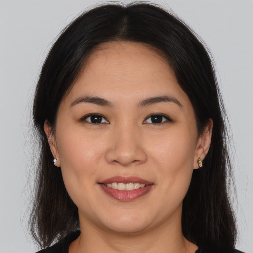 Joyful white young-adult female with long  brown hair and brown eyes