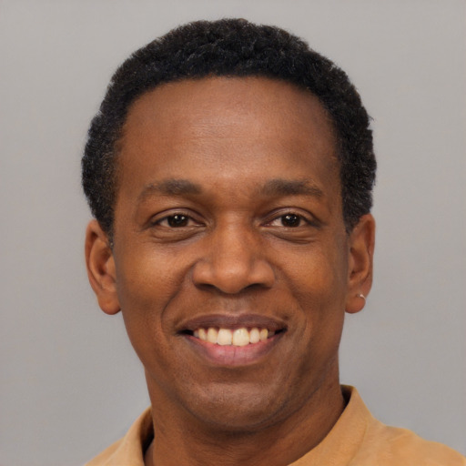 Joyful latino adult male with short  black hair and brown eyes