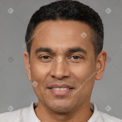 Joyful latino adult male with short  black hair and brown eyes