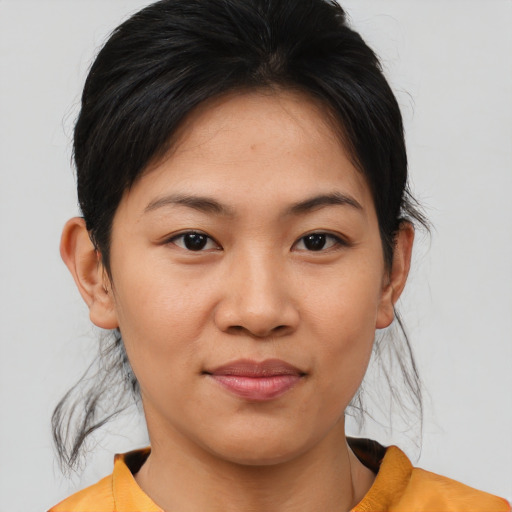 Joyful asian young-adult female with medium  brown hair and brown eyes