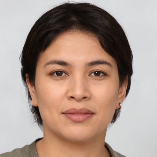 Joyful asian young-adult female with medium  brown hair and brown eyes