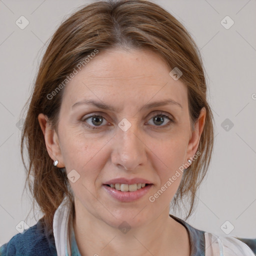 Joyful white adult female with medium  brown hair and grey eyes