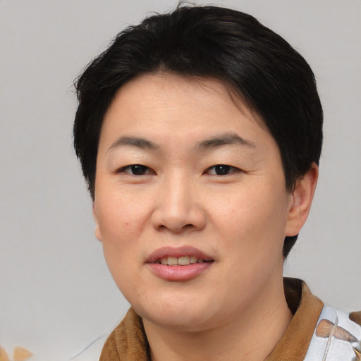 Joyful asian young-adult female with short  black hair and brown eyes