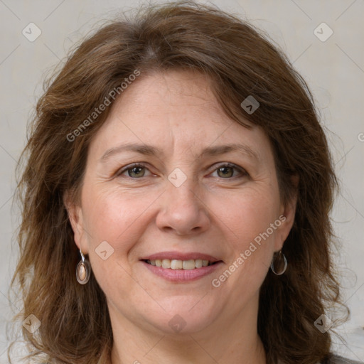 Joyful white adult female with medium  brown hair and grey eyes